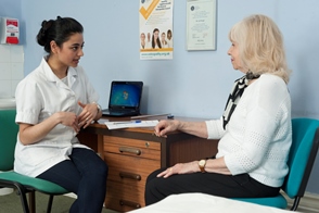 Female osteopath with elderly lady