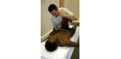 Male osteopath with male patient
