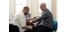 Osteopath with middle-aged man consultation 2