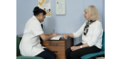 Female osteopath consultation with elderly woman