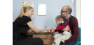 Female osteopath with parent of toddler