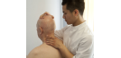 Male osteopath and elderly man