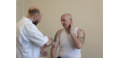 Male osteopath and middle aged man - exercise