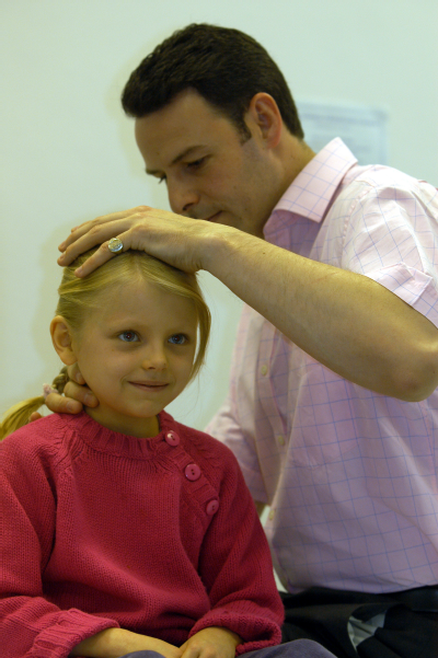 Male osteopath with female child