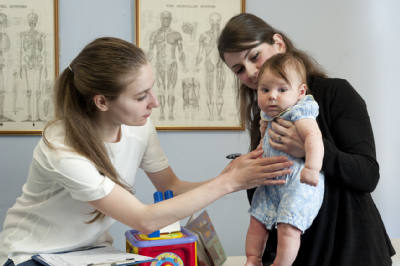 Female osteopath with mother and baby 2