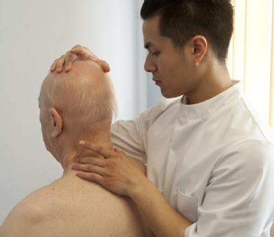 Male osteopath and elderly man