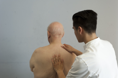 Male osteopath and elderly man 3