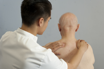 Male osteopath and elderly man 2