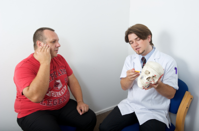 Male osteopath with male patient - skull