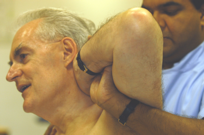 Male osteopath and middle aged man - back 2