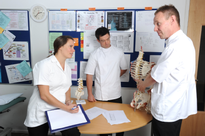 Osteopath and students with skeleton