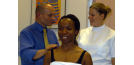 Male and female osteopath treating female