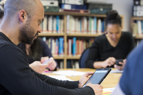 A group of osteopaths using their phones