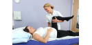 Female osteopath treating pregnant woman