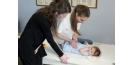 Female osteopath treating baby