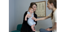 Female osteopath treating baby 4