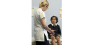 Female osteopath treating young child 3