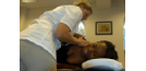 Female osteopath treating female - back and shoulder