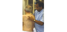 Male osteopath and middle aged man - back