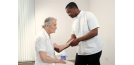 Osteopath and elderly woman - arms