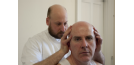 Osteopath with middle-aged man - head