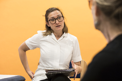 An osteopath discussing treatment with patient