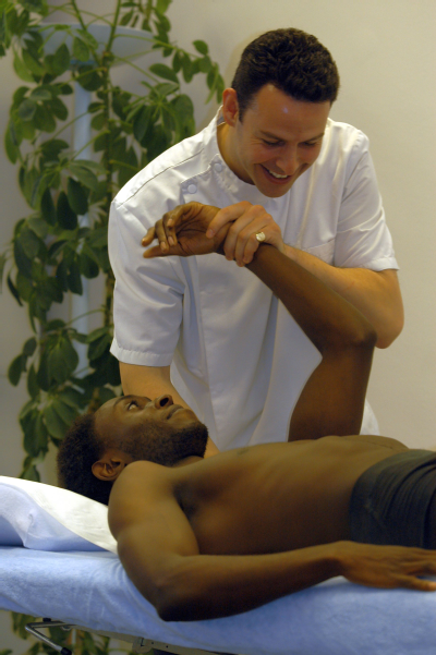 Male osteopath and male patient - shoulder