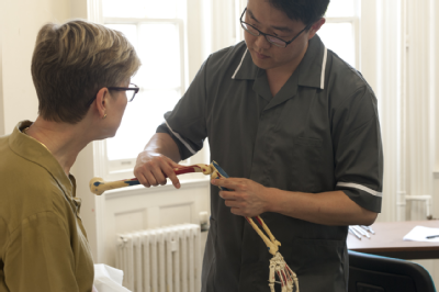 Osteopath with woman - skeletal arm 2