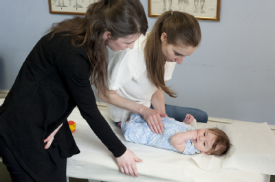 Female osteopath treating baby