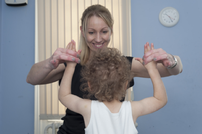 Female osteopath treating toddler 2