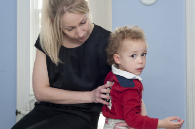Female osteopath treating toddler