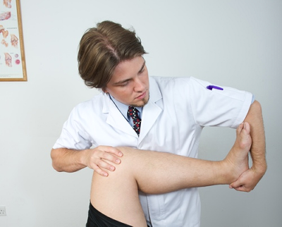 Male osteopath with male patient - leg