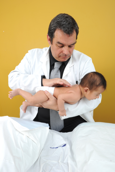 Male osteopath and baby