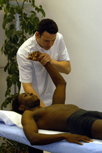Male osteopath with male patient