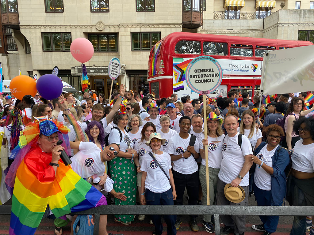 A group of people in GOsC Pride logo t shirts celebrating Pride in London 2023